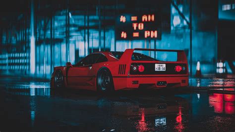 a red sports car parked in the rain