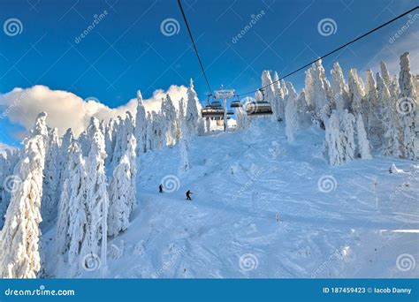 Chair Lift in Poiana Brasov Ski Resort, Skiers and Snowboarders Enjoy ...