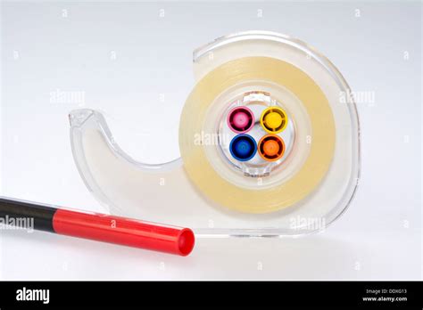 Tape dispenser and colorful markers Stock Photo - Alamy