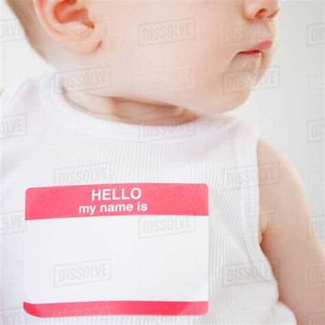 Baby wearing name tag - Stock Photo - Dissolve