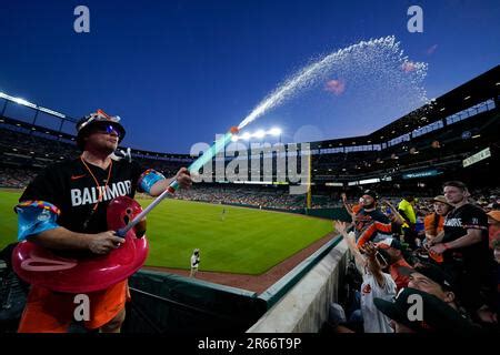 Mr. Splash sprays fans in the "Bird Bath Splash Zone" during the seventh inning of a baseball ...