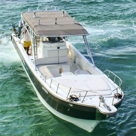 a man standing on the back of a boat in the middle of the ocean,