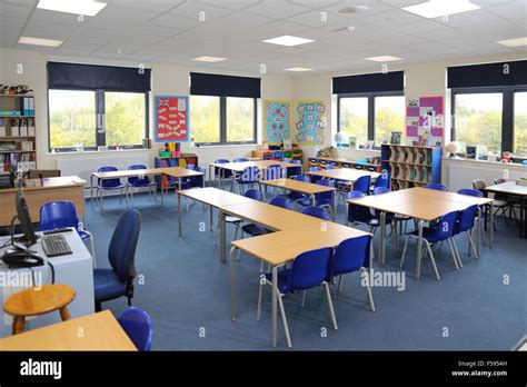 A classroom in a newly built UK junior school. Shows desks, chairs and ...