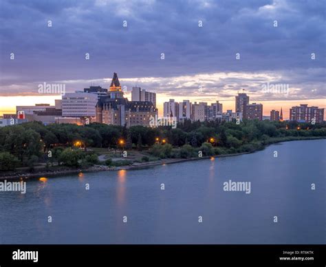 Saskatoon skyline at night along the Saskatchewan River. Saskatoon is a city in the Canadian ...