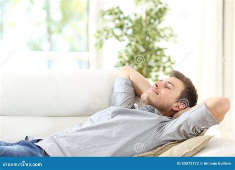 Relaxed Man Resting on a Couch at Home Stock Photo - Image of house, breath: 80072172