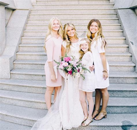 the bride and her three daughters are posing on the steps