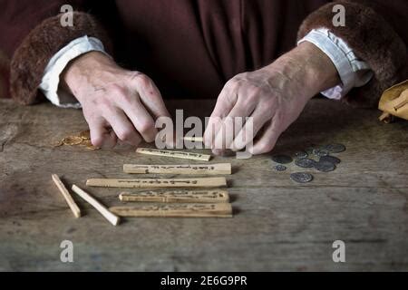 Medieval merchant counting money using tally sticks Stock Photo - Alamy