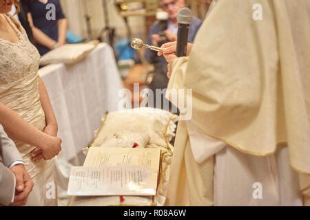 Priest blessing wedding rings during the ceremony Stock Photo: 91892778 ...