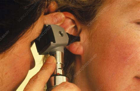 Otoscope ear examination of a woman - Stock Image - M920/0294 - Science ...