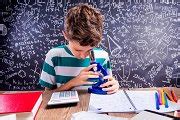 School boy at the desk with microscope, big blackboard | School & Education Stock Photos ...
