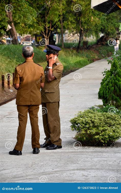 Two Sri Lankan Railway Police Officials Stand On Station Platform Sri ...