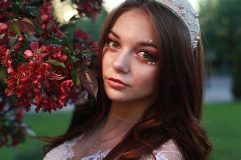 Premium Photo | Close-up portrait of woman by red flowers