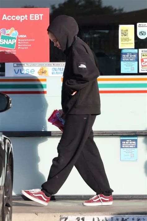 Shiloh Jolie-Pitt spotted at 7-11 on a snack run sporting a black hoodie, track pants and face ...