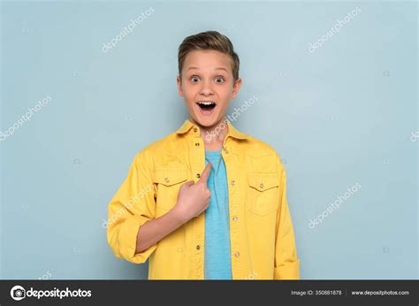 Surprised Cute Kid Pointing Finger Blue Background Stock Photo by ©IgorVetushko 350881878