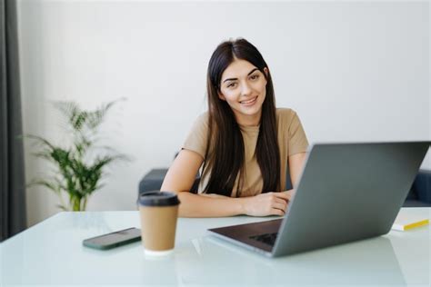 Free Photo | Beautiful young woman working on her laptop in her office ...