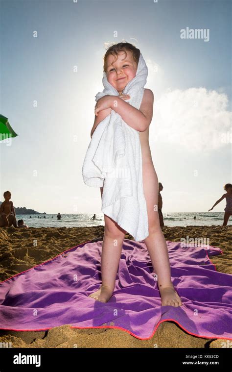 Girl / children / kids / kid drying herself with a towel after swimming ...