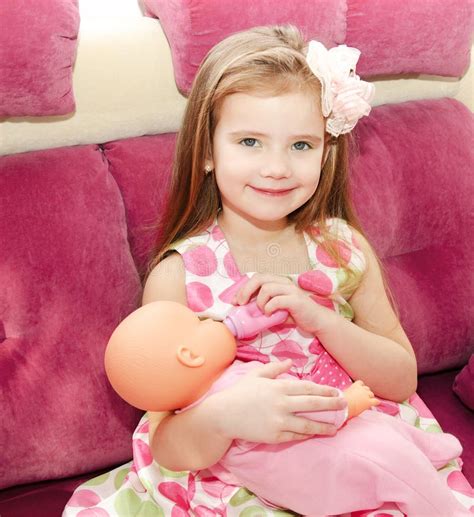 Cute Smiling Little Girl Playing With A Doll Stock Image - Image of holding, caucasian: 41212043