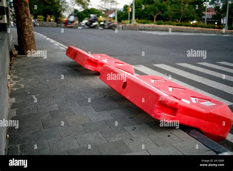 Orange plastic construction barriers on the side of street Stock Photo ...