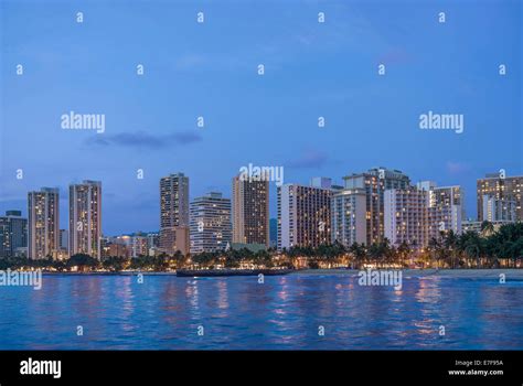 Illuminated city skyline on waterfront, Honolulu, Hawaii, United States Stock Photo - Alamy