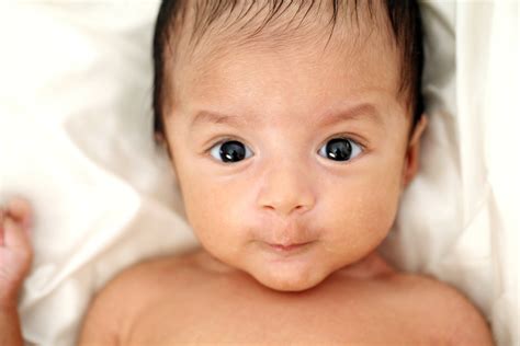 newborn baby with bright dark eyes - Wyoming Department of Health