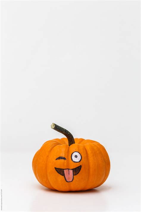 "Pumpkin With Silly Emoticon Face" by Stocksy Contributor "Amanda Large" - Stocksy