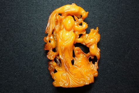 Amber carving of Guanyin surrounded by auspicious creatures. Qing period, China | Stone carving ...