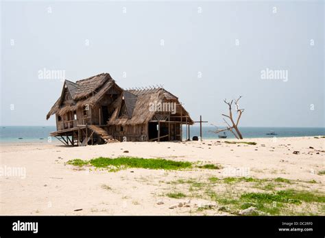 Thatched beach hut at seaside Stock Photo - Alamy