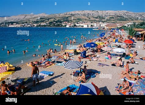 Pag beach. Crowded beach near old town Pag, Croatia Stock Photo - Alamy