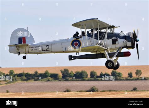 Fairey Swordfish torpedo bomber biplane in Royal Navy Fleet Arm markings landing after ...