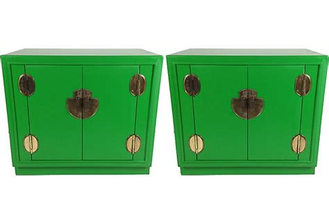 two green cabinets with brass handles and knobs on the doors are shown side by side