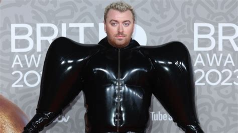 Sam Smith makes a bold fashion statement in a inflatable black latex jumpsuit at the BRIT Awards ...