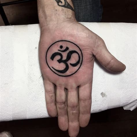 Black Om symbol tattoo on the left palm | Circle tattoo, Tattoos, Om ...