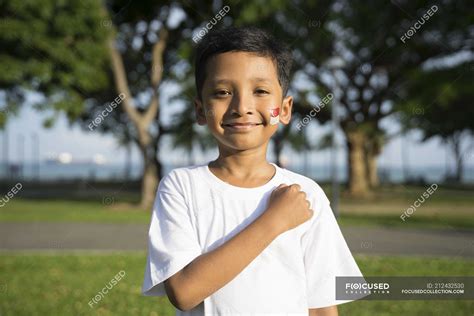 A kid taking the Singapore pledge. — child, joy - Stock Photo | #212432530