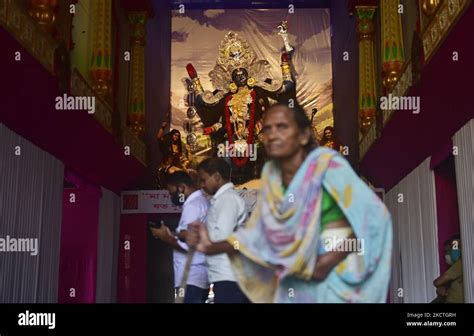 Visitors come to see a Hindu goddess Kali in a puja pandal before the day of Kali puja festival ...