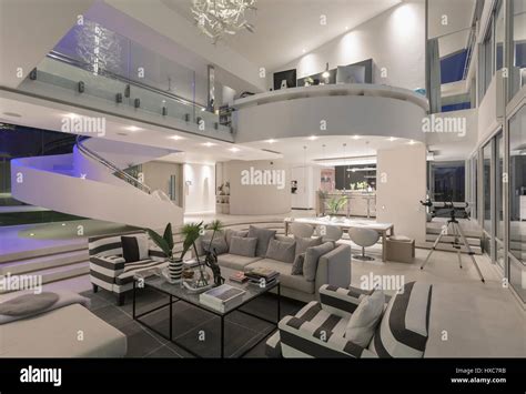 Illuminated modern luxury home showcase interior open plan Stock Photo - Alamy