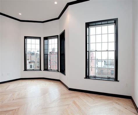 Black door frames and reclaimed maple floors | White walls, Black trim ...