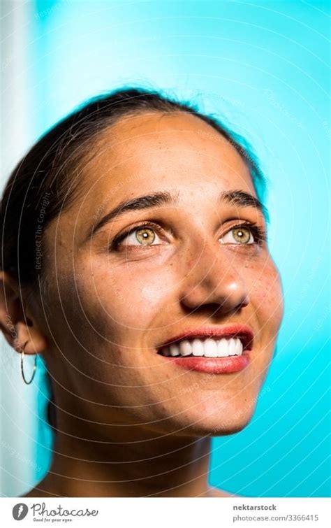 Face of Young Indian Woman Smiling on Blue Background - a Royalty Free Stock Photo from Photocase