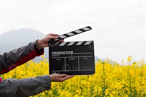 Hand holding clapper board concept, creative photo of blackboard for film making industry ...