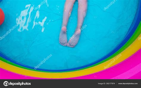 Kids Feet Laying Colorful Rainbow Inflatable Swimming Pool Young Girl ...