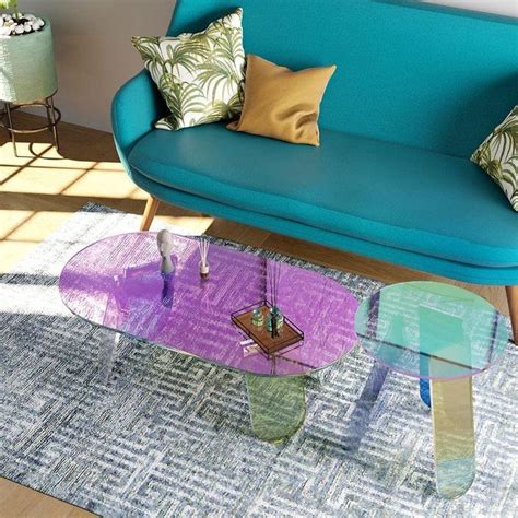 a living room with blue couch, coffee table and colorful rug