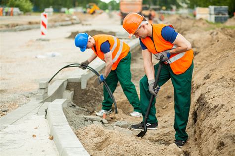 Labourers On A Road Construction Stock Photo - Download Image Now - iStock