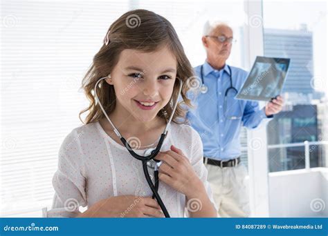 Girl Checking Her Own Heartbeat Using a Stethoscope Stock Image - Image of emergency, heart ...