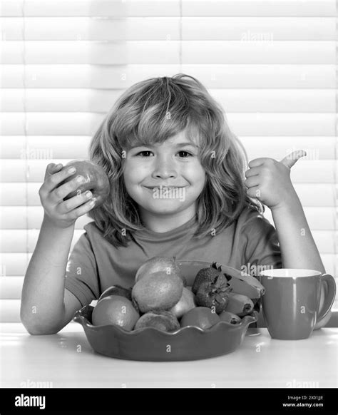 Kid eating apple. Portrait of child eat fresh healthy food in kitchen ...