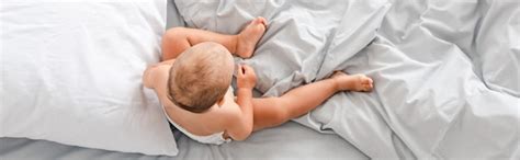 Premium Photo | Panoramic shot of little barefoot child sitting on bed ...