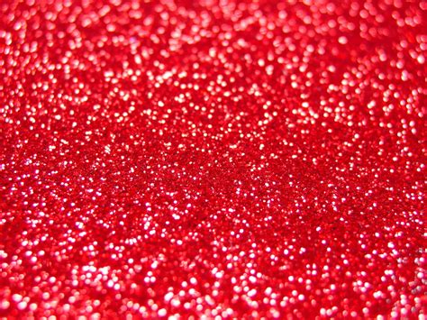 Download A bright and vibrant red glitter background. | Wallpapers.com