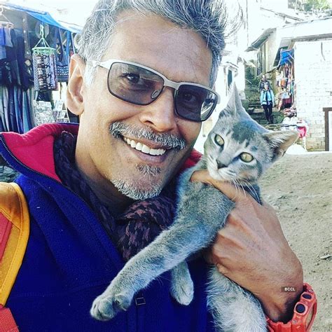 Milind Soman stops by to hold this adorable kitty during on of his vacations - Photogallery