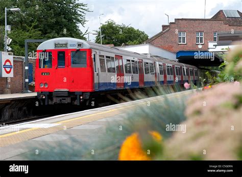 London Underground tube train traveling overground on the Metropolitan ...