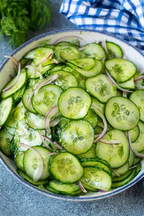 Cucumber salad in a serving bowl with sliced English cucumbers, red ...