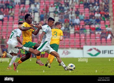 Bangladeshi defender Isa Faysal (R) and Australia forward Nestory Irankunda (L) during their ...