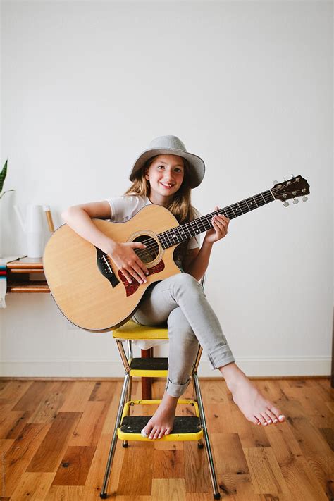 "Young Girl Playing Guitar" by Stocksy Contributor "Erin Drago" - Stocksy